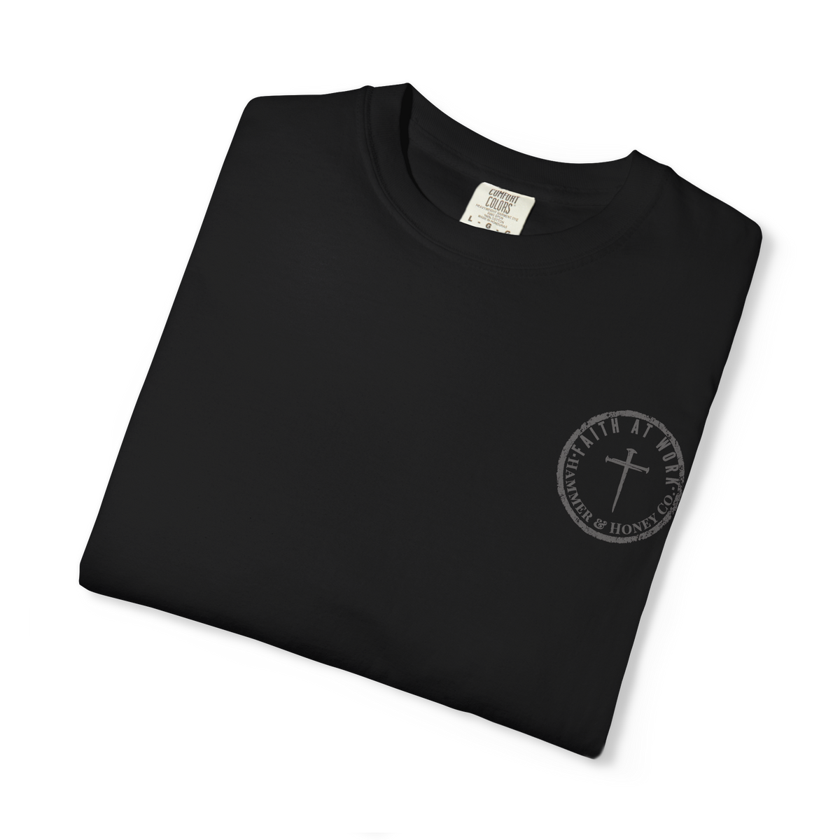 A folded black crewneck t-shirt with a small gray circular chest graphic featuring a cross and the text 'WITH ALL MY HEARTS TO THE FAMILY & HOME OF CHRIST'.